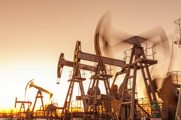 Oil pump rig. Oil and gas production. Oilfield site. Pump Jack are running. Drilling derricks for fossil fuels output and crude oil production. War on oil prices. Global coronavirus COVID 19 crisis. Oil pump rig. Oil and gas production. Oilfield site. Pump Jack are running. Drilling derricks for fossil fuels output and crude oil production. Global coronavirus COVID 19 crisis. War on oil prices. oil wellhead stock pictures, royalty-free photos & images