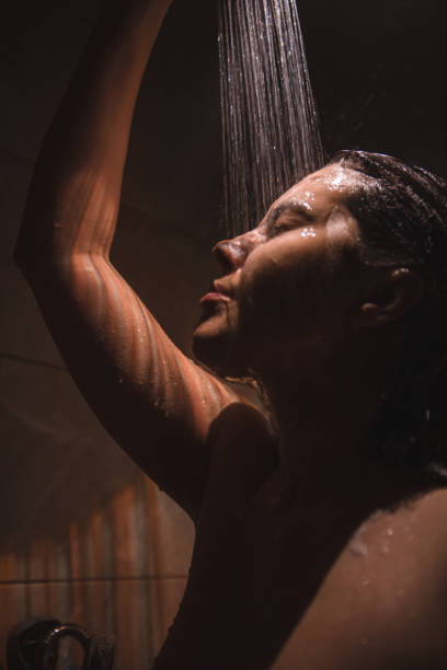 istock young pretty woman taking shower 1225330933