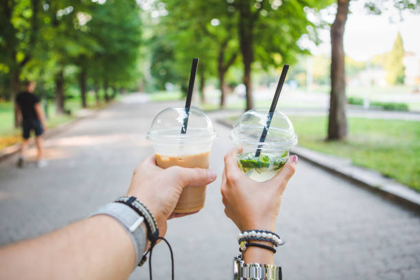 istock couple hands holding cup with cooling drink 1225330977