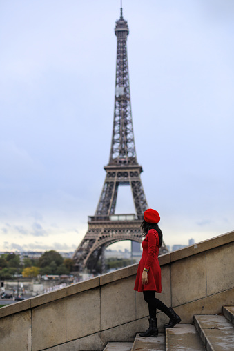 asian young woman  walking in front of Eiffel Tower