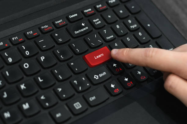 Red button 'Learn' on keyboard stock photo