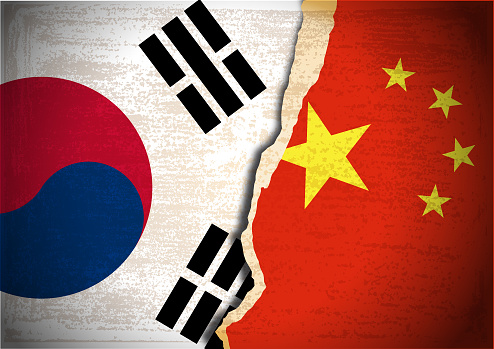 Vector of Conflict concept with Flag of South Korea and China on grunge textured background. EPS Ai 10 file format.