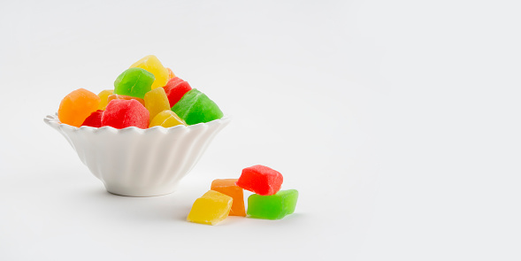 Variety of jelly candies and colorful sweets for traditional sweet and feast festival (called bayram in Turkish). Colorful Turkish delights in isolated white background. This feast festival coming after Ramadan month and related with religion and also called Ramadan Feast.
