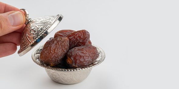Date fruits (medjool) on a silver traditional plate for traditional sweet and feast festival (called bayram in Turkish). This feast festival coming after Ramadan month and related with religion and also called Ramadan Feast.