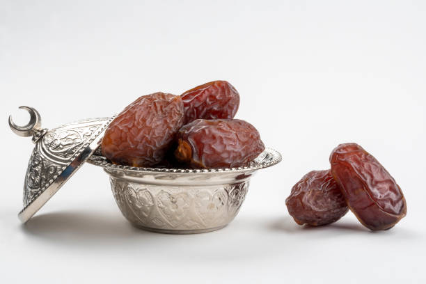 Sweet Medjools (date fruits) for bairam (bayram). Date fruits (medjool) on a silver traditional plate for traditional sweet and feast festival (called bayram in Turkish). This feast festival coming after Ramadan month and related with religion and also called Ramadan Feast. date fruit stock pictures, royalty-free photos & images