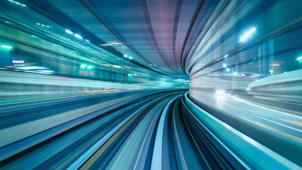 High Speed Train Abstract Panorama Tokyo Japan Panorama of motion blurred high speed train driving along the rails through an illuminated tunnel at night. Edited, Composite. Long Time Exposure. Odaiba, Tokyo, Japan, Asia city zoom out stock pictures, royalty-free photos & images