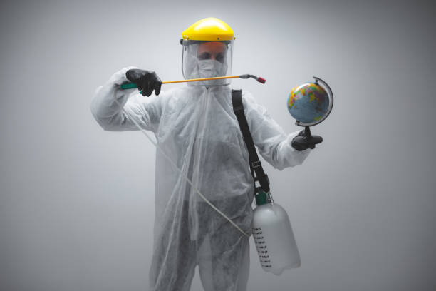 istock Scientist spraying Earth globe to decontaminate planet from viruses and germs. 1225339981