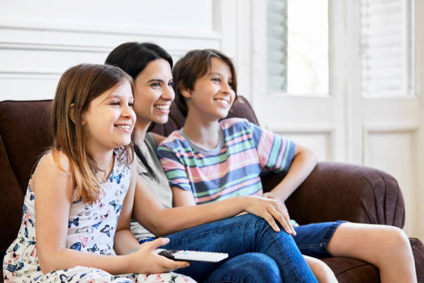 istock Happy family watching TV at home during quarantine 1225340899