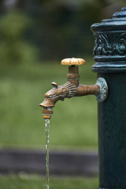 istock Close-up of old-style column with drinking water in public park, selective focus 1225342457