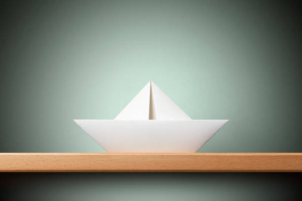 Paper boat on the shelf.