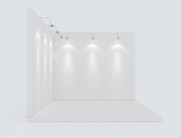 istock The white wall has 3 lights. For exhibitions Located on the floor 10 cm high, white, display, wall display. 3D render. 1225345802