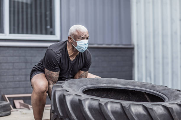 istock A black male working out wearing a face mask during virus outbreak 1225346183