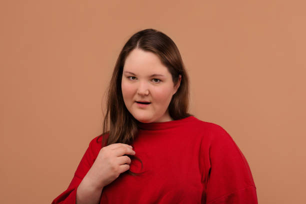 istock A beautiful young girl looks right into the frame. 1225346333