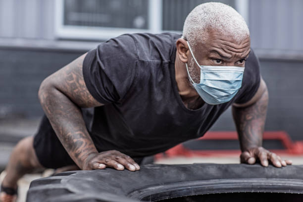 A black male working out wearing a face mask during virus outbreak