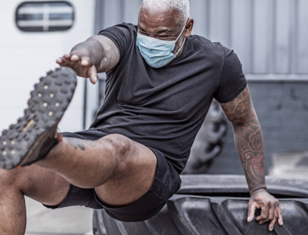 istock A black male working out wearing a face mask during virus outbreak 1225346923