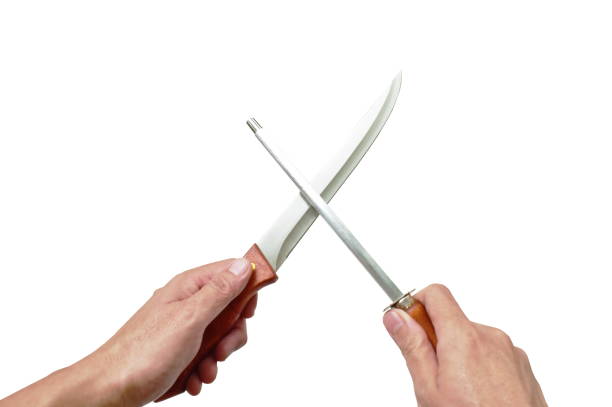 istock hand holding kitchen knife with sharpening steel on white background 1225346939