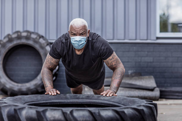 istock A black male working out wearing a face mask during virus outbreak 1225347218