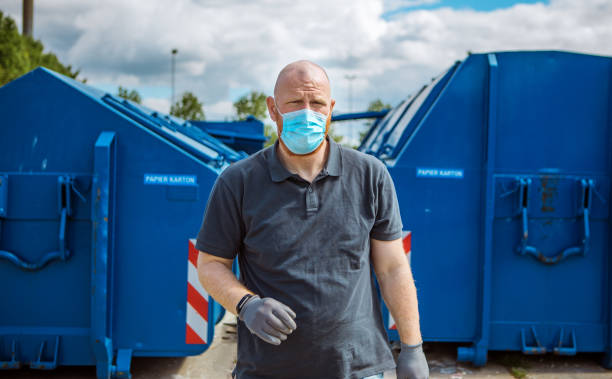 istock Manual worker at a recycling centre during corona virus outbreak 1225347219