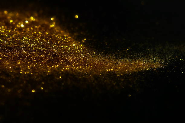 istock golden sparkles on black background. Festive, X-mas backdrop. Copy space 1225347258