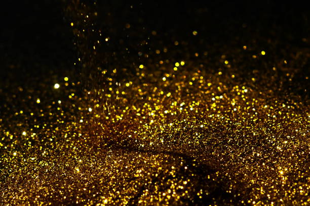 istock golden sparkles on black background. Festive, X-mas backdrop. Copy space 1225347262
