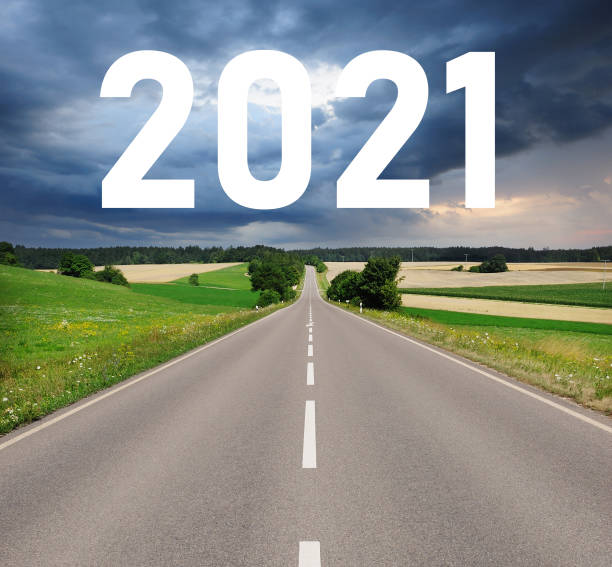 istock 2021 sign over country road , dramatic sky 1225347273