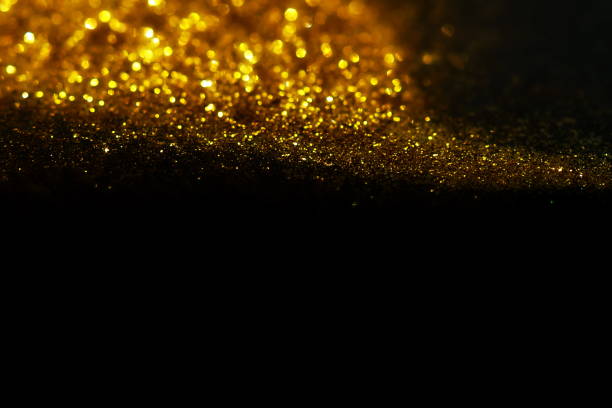 istock golden sparkles on black background. Festive, X-mas backdrop. Copy space 1225347349