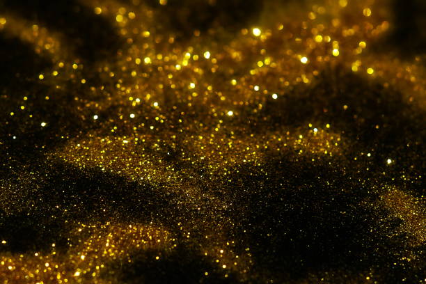 istock golden sparkles on black background. Festive, X-mas backdrop. Copy space 1225347385