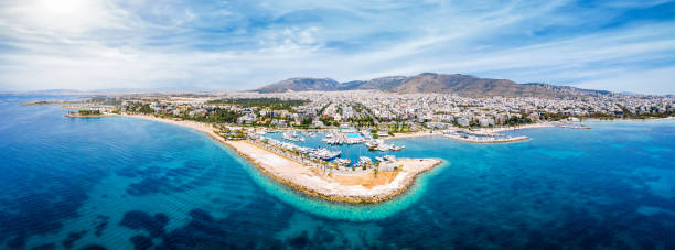 Panoramic aerial view to the coastline of Glyfada district, south Athens, Greece, Panoramic aerial view to the coastline of Glyfada district, south Athens, Greece, with yacht marinas, beaches and turquoise sea attica stock pictures, royalty-free photos & images