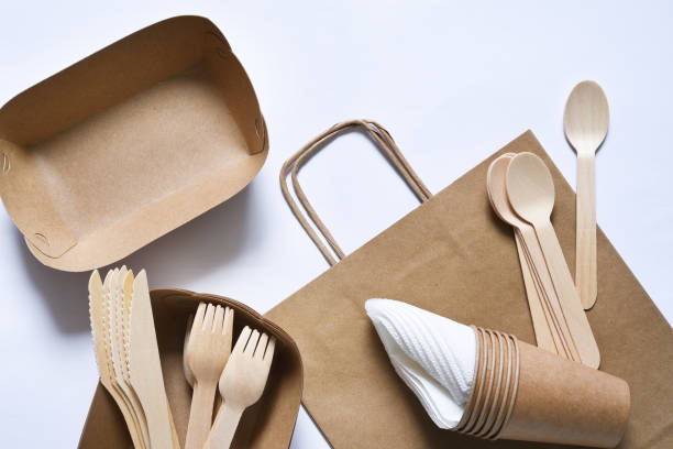 istock Paper bag with a picnic set: plate, fork, glass, napkins. Caring for the environment.Flatly. 1225348178