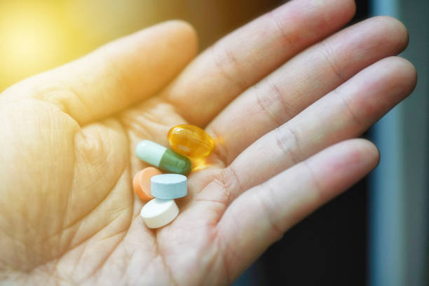 istock A hand holding lots of pills in a hand 1225348526