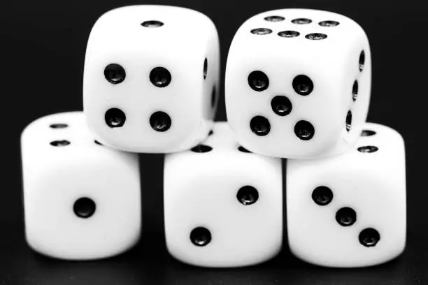 Photo of Macro closeup of five dice in front of dark background