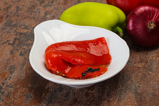 Marinated baked red bell pepper in the bowl