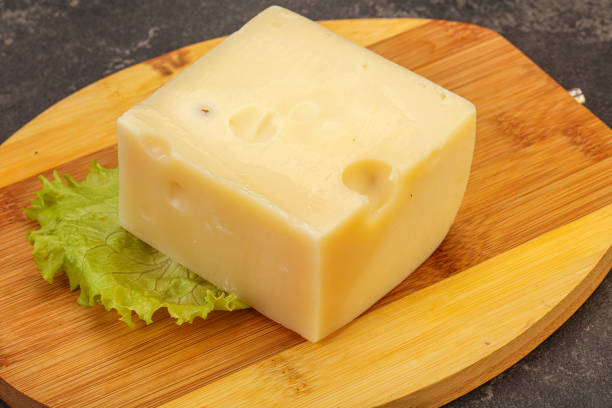 istock Emmental cheese over wooden board 1225353979