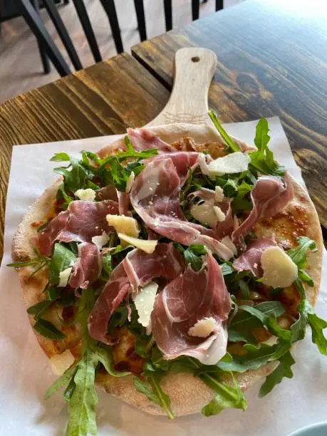 Parma ham pizza with cheese rocket