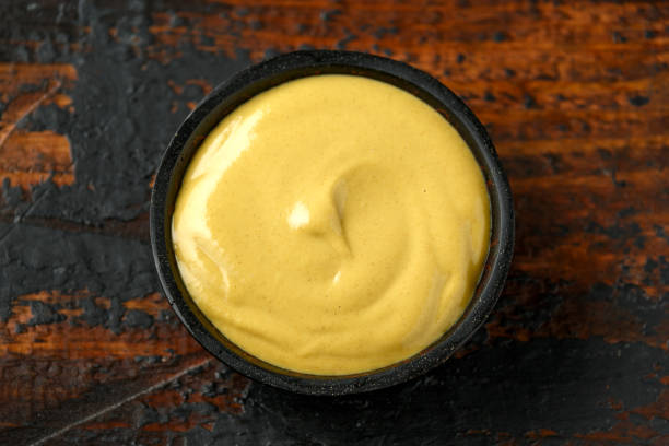 istock Dijon mustard in bowl on wooden table. 1225355173