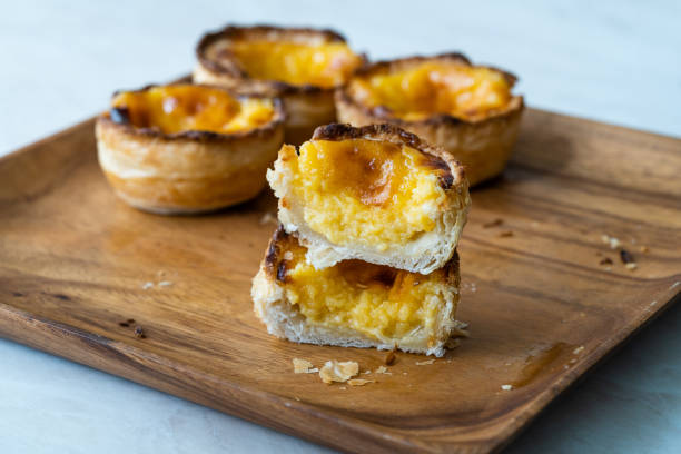 istock Pasteis de Nata or Belem Tart. Portuguese Custard made with Egg, Cinnamon, Sugar and Flour on Wooden Plate. 1225356982
