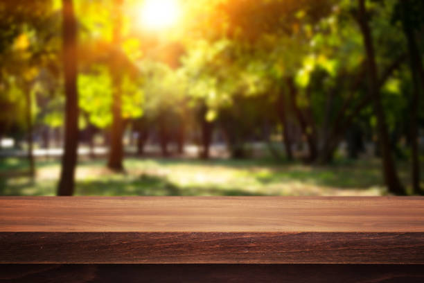 istock Wooden desk on bokeh blur abstract natural background 1225358434