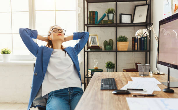 istock Relaxed woman sitting at table with gadgets 1225358529