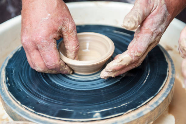istock The potter makes pottery dishes on potter's wheel. 1225359209
