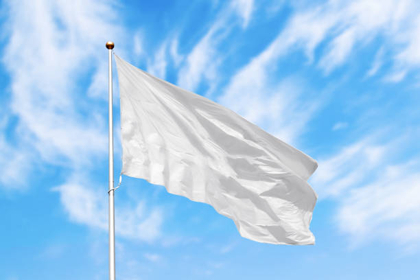 istock Blank white flag with copy space against blue cloudy sky 1225359288