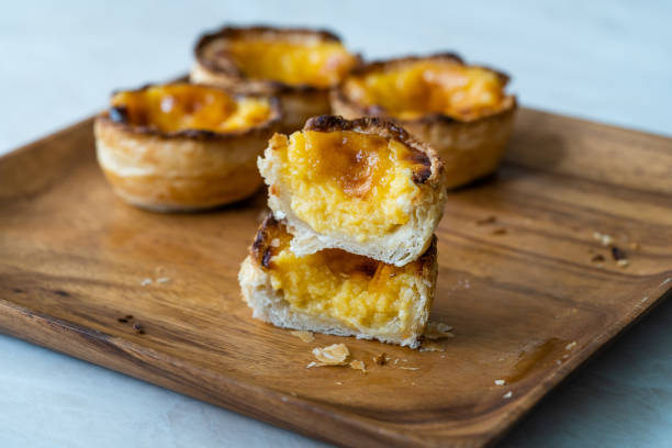 istock Pasteis de Nata or Belem Tart. Portuguese Custard made with Egg, Cinnamon, Sugar and Flour on Wooden Plate. 1225359561