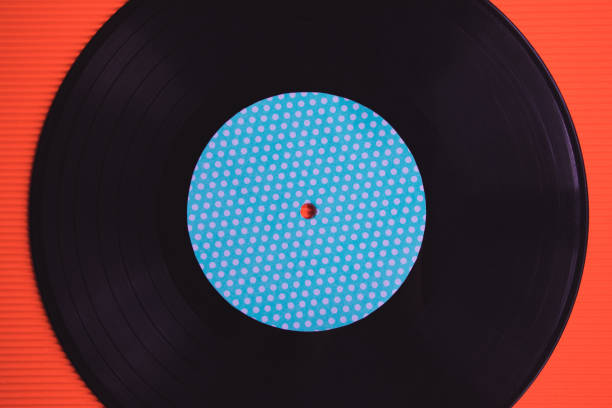 istock Black music vinyl on a red background top view 1225359691