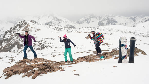 istock Three happy snowboarders make fun and enjoy in beautiful mountain 1225359716