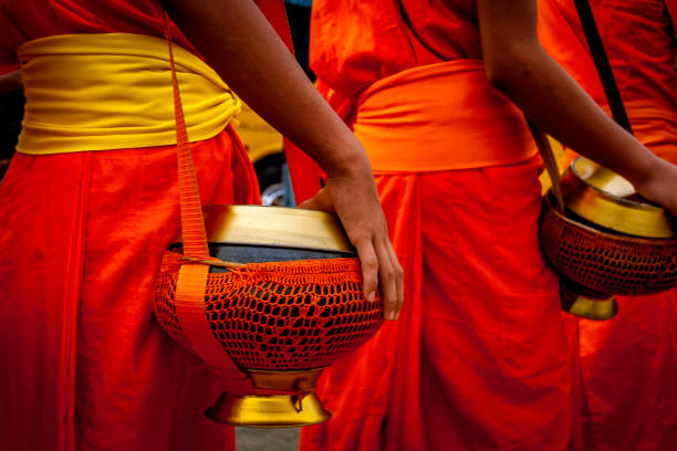 istock Monks collecting alms in Luang Prabang, Laos 1225360360