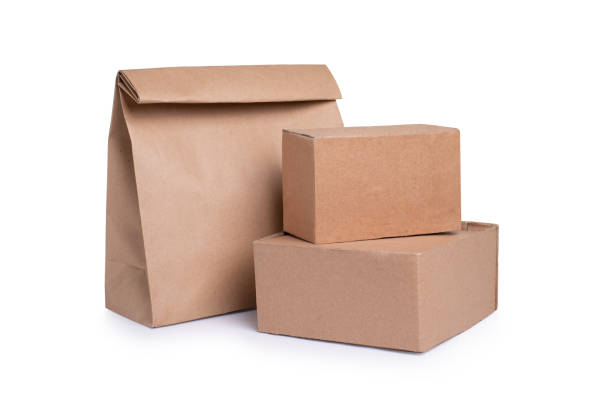 istock Cardboard boxes and paper bag isolated on white 1225360642