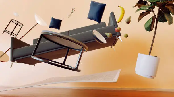 Concept of sofa, table and other furniture items from a living room flying through the air with zero gravity. Maybe due to an earthquake or paranormal activity.