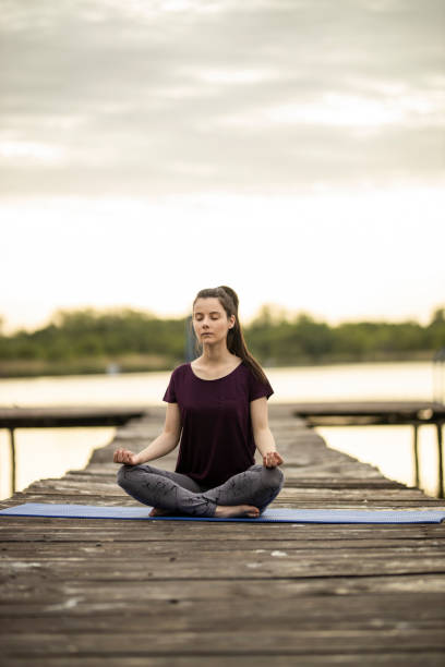 istock Young woman in Half Lotus pose 1225366416