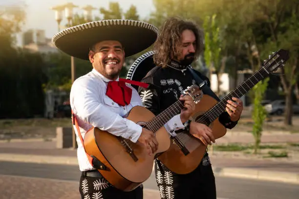 Photo of Mexican musicians play musical instruments in the city.