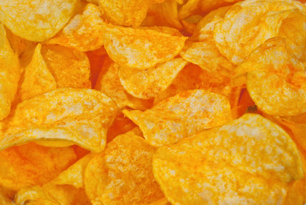 istock Texture of yellow crispy chips. Lots of chips close up. 1225373233