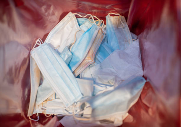 istock Surgical mask inside medical waste box 1225373312